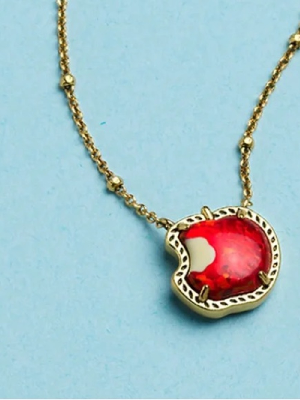 Kendra Scott Disney Snow White necklace features a bitten apple pendant